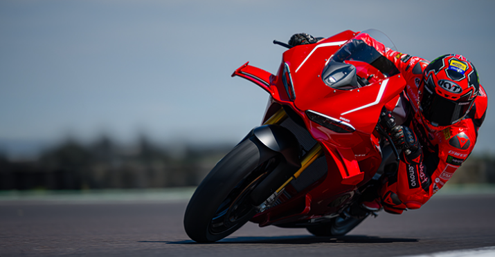 Superbike leaning into a corner on track